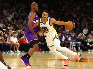 Oct 25, 2022; Phoenix, Arizona, USA; Golden State Warriors guard Jordan Poole (right) controls the ball against Phoenix Suns guard Chris Paul in the second half at Footprint Center. Mandatory Credit: Mark J. Rebilas-USA TODAY Sports