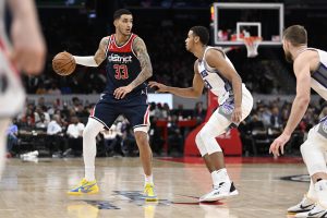 Mar 18, 2023; Washington, District of Columbia, USA; Washington Wizards forward Kyle Kuzma (33) dribbles as Sacramento Kings forward Keegan Murray (13) defends during the second half at Capital One Arena. Mandatory Credit: Brad Mills-USA TODAY Sports