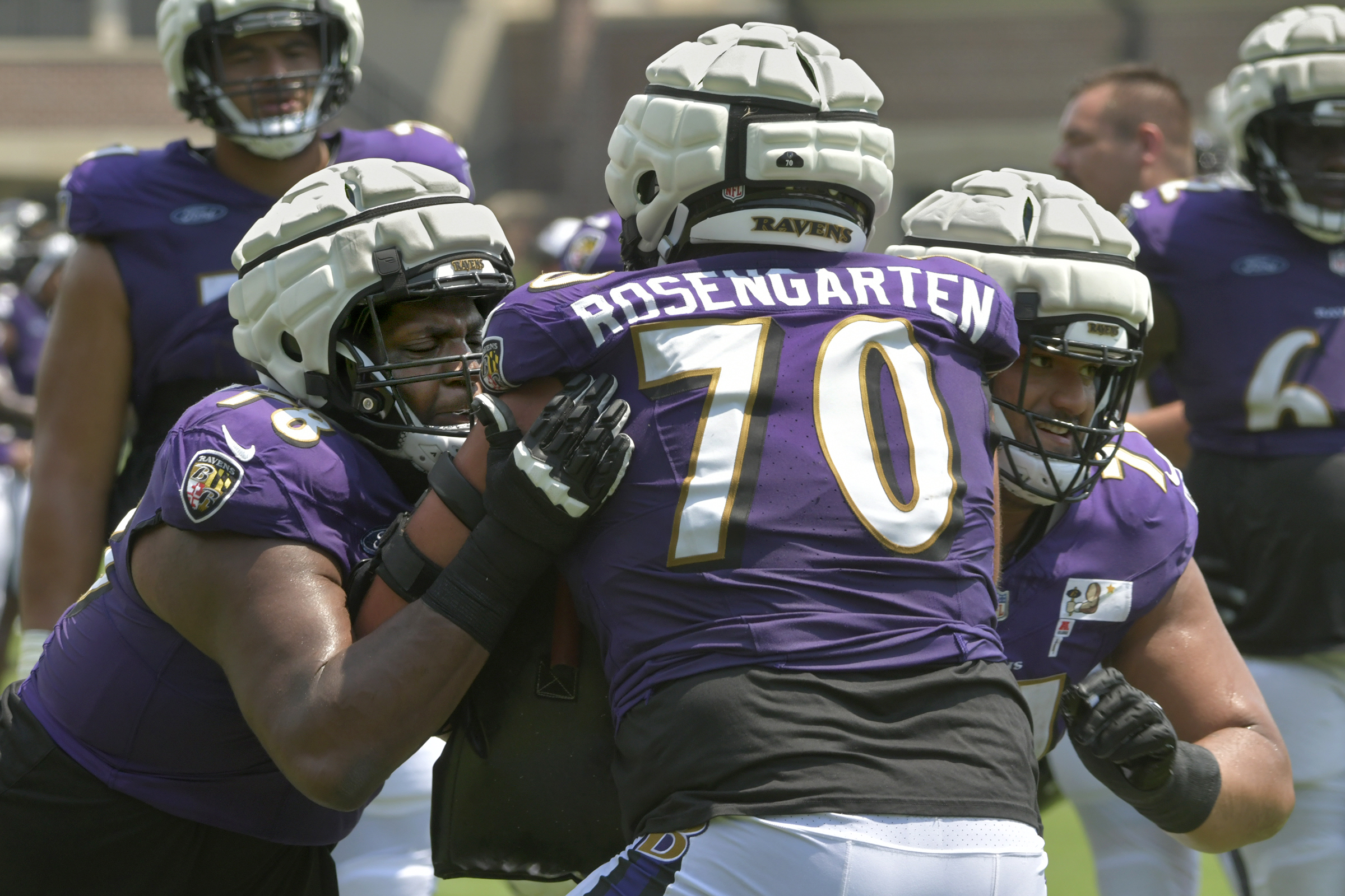 The Ravens' Darrell Simpson, left, and Malaesala Aumavae-Laulu, right, drill...