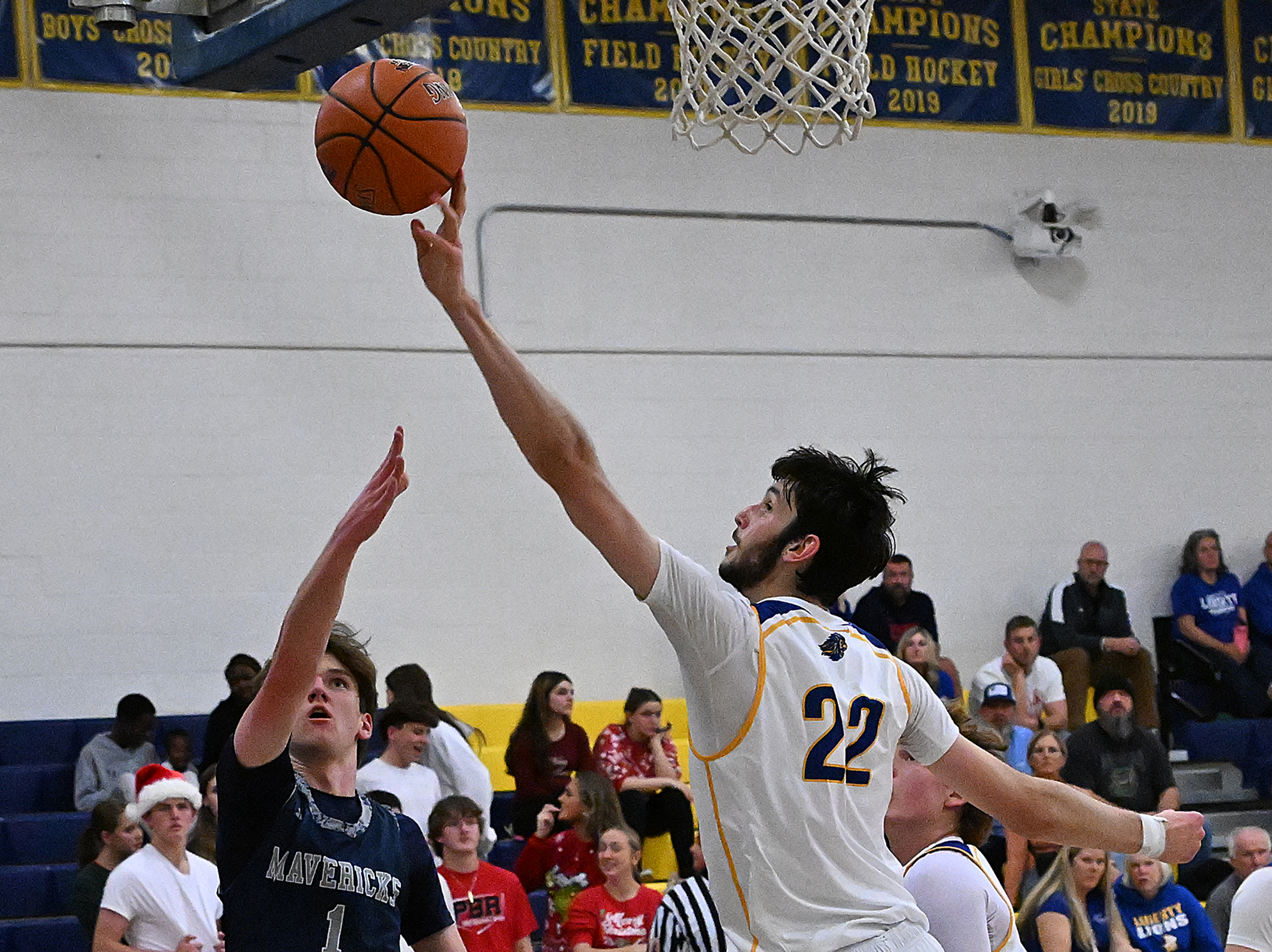 Liberty #22, Ethan Hart blocks layup from Manchester Valley #1,...