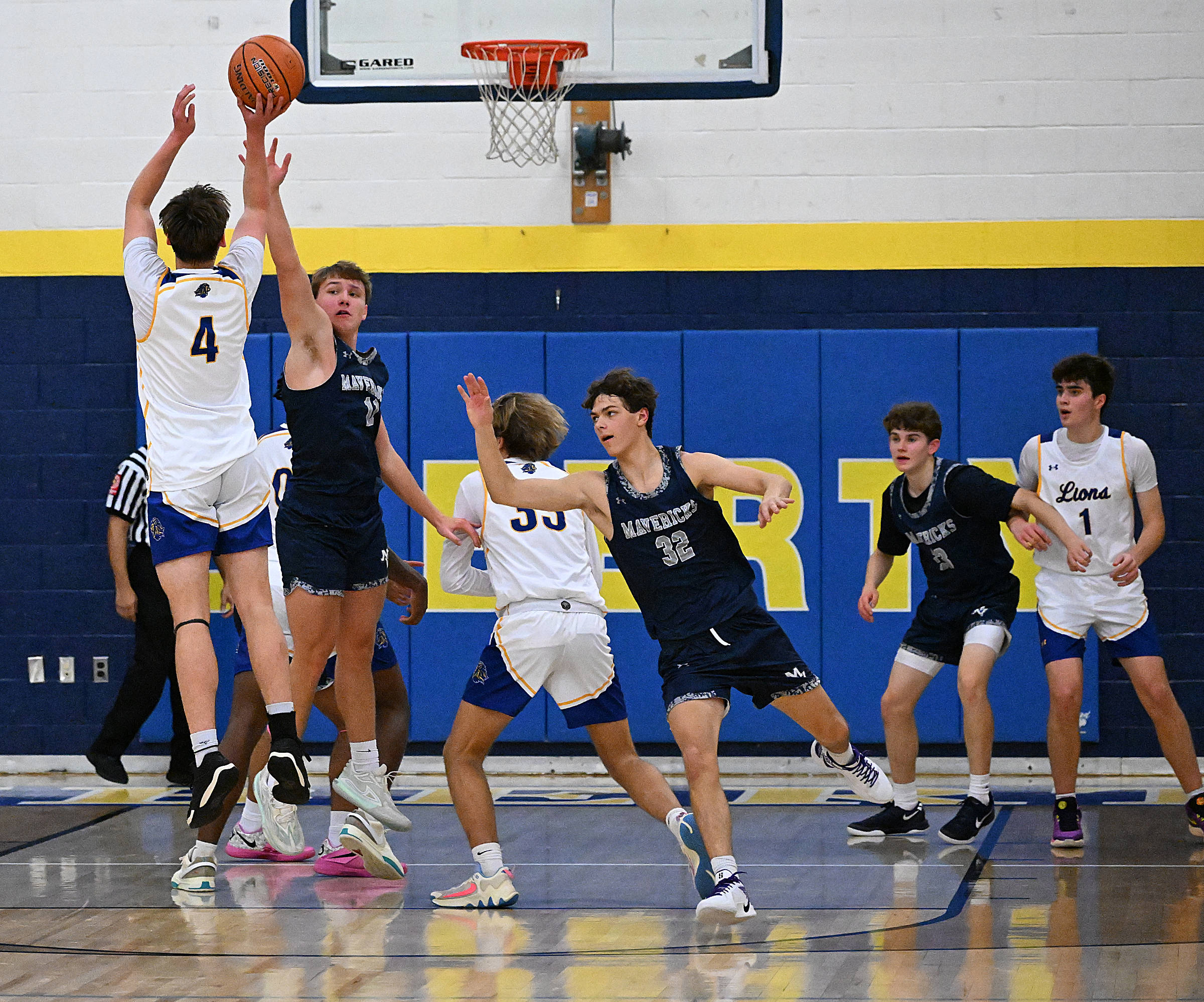 Liberty #4, Brady Berger sinks a three at the top...