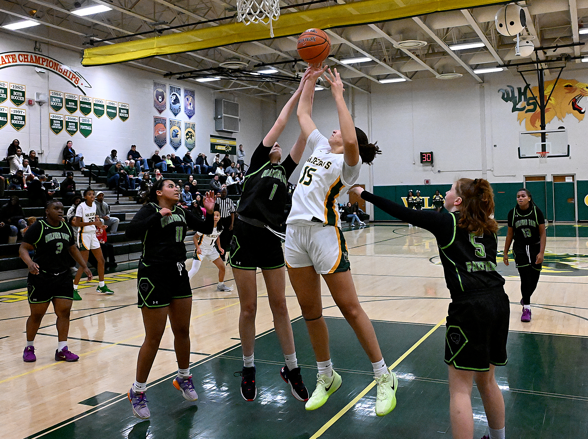 Wilde Lake #15, Quinn Corkeron, pulls down an offensive rebound...