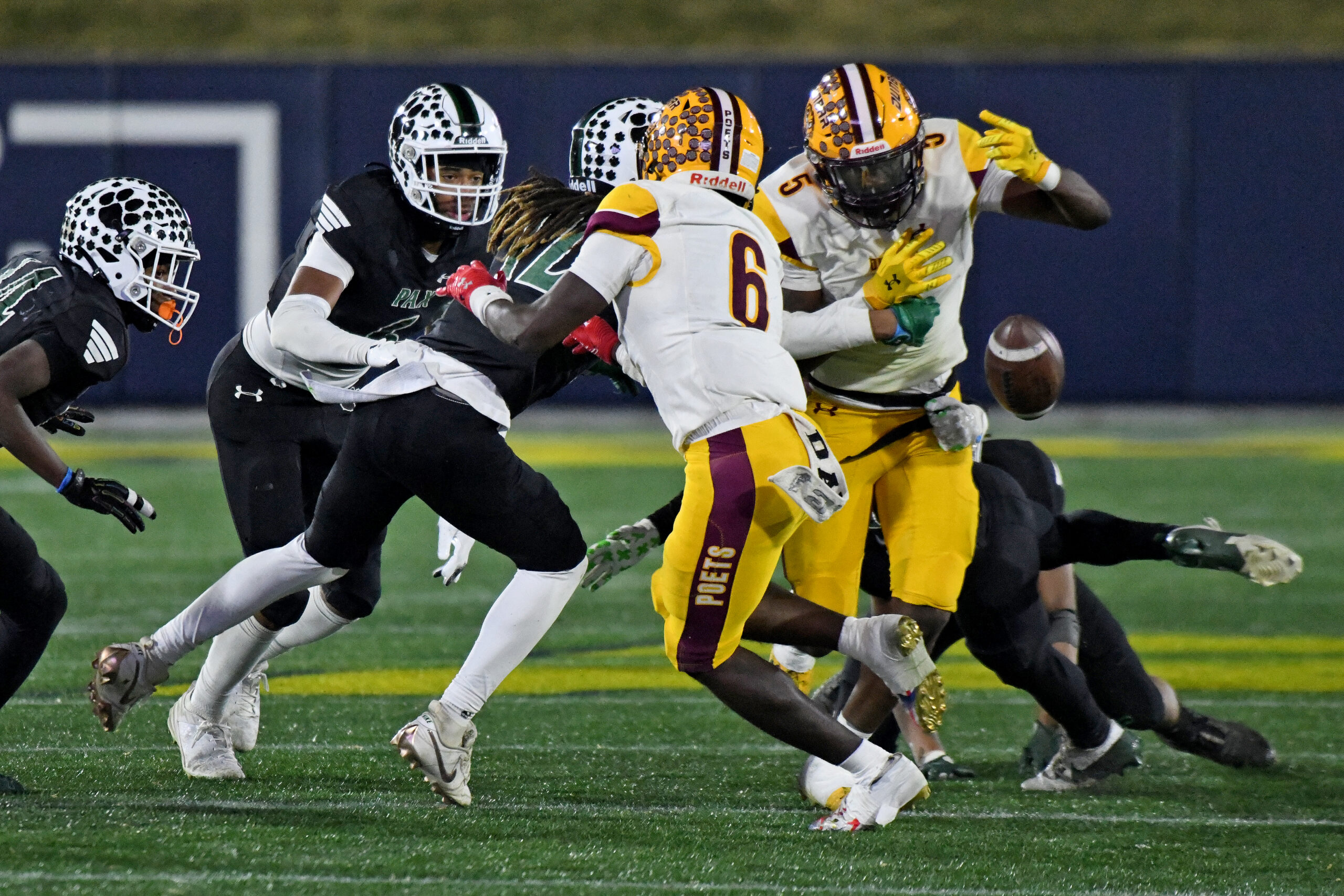 Dunbar's Brian Collins, right, fumbles in the fourth quarter against...