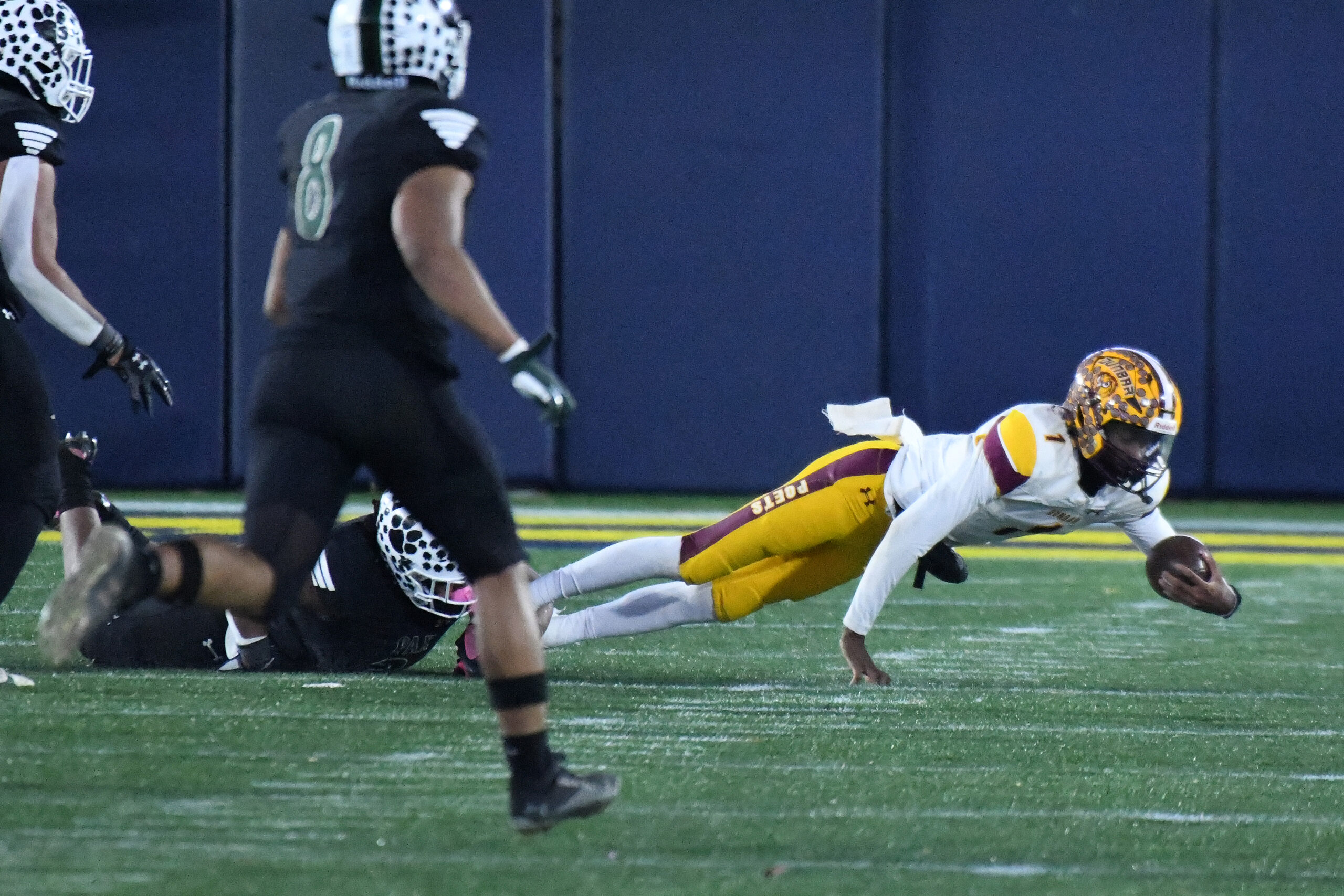 Dunbar QB Savion Witherspoon is sacked by King Jones, Patuxent,...