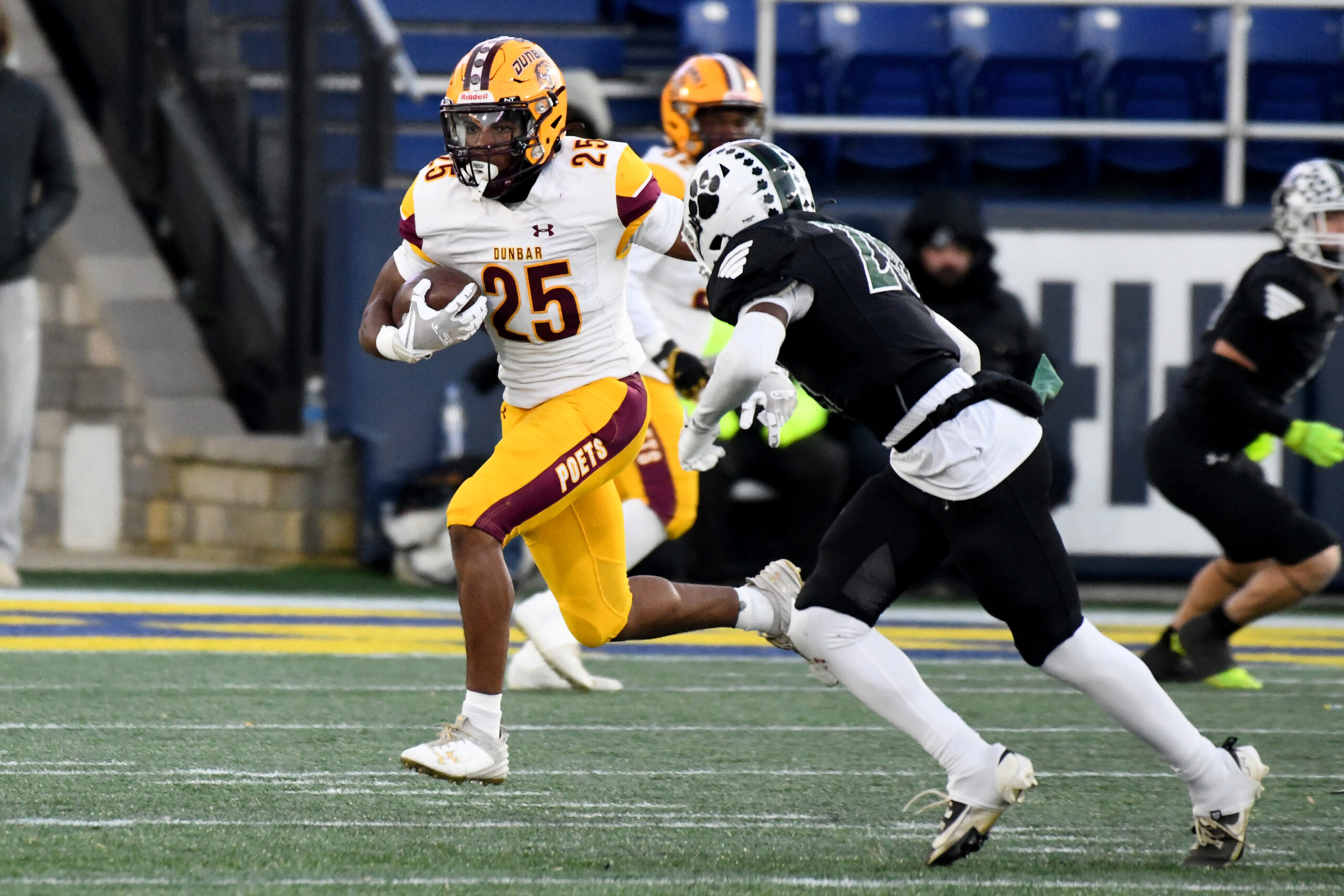 Cordae James, Dunbar runs the ball as Evan Jones, Patuxent,...