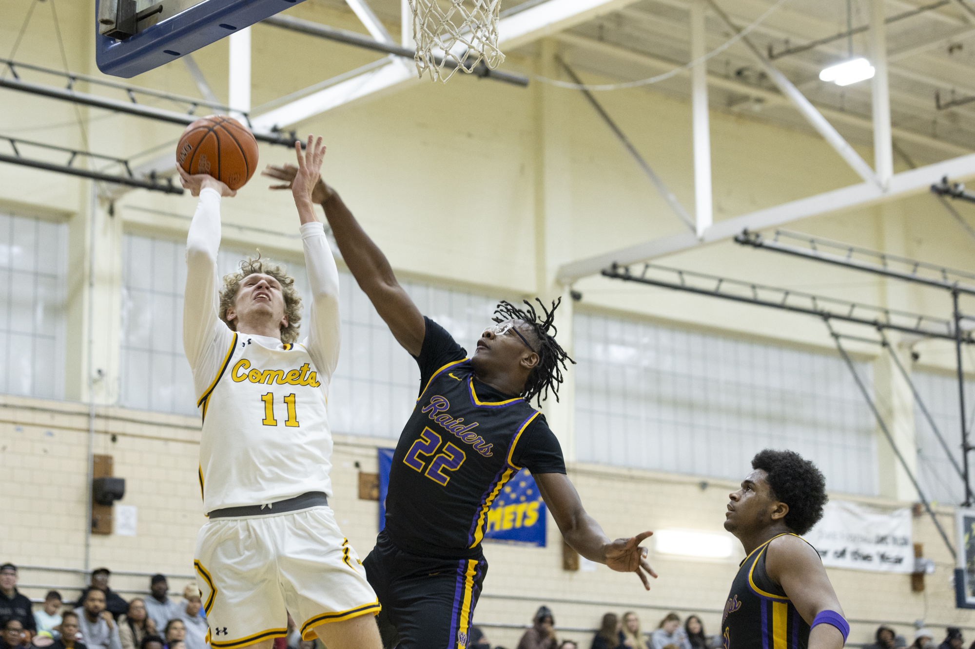 Darrell White fouls Catonsville’s Nate Holub-Smith as he goes up...