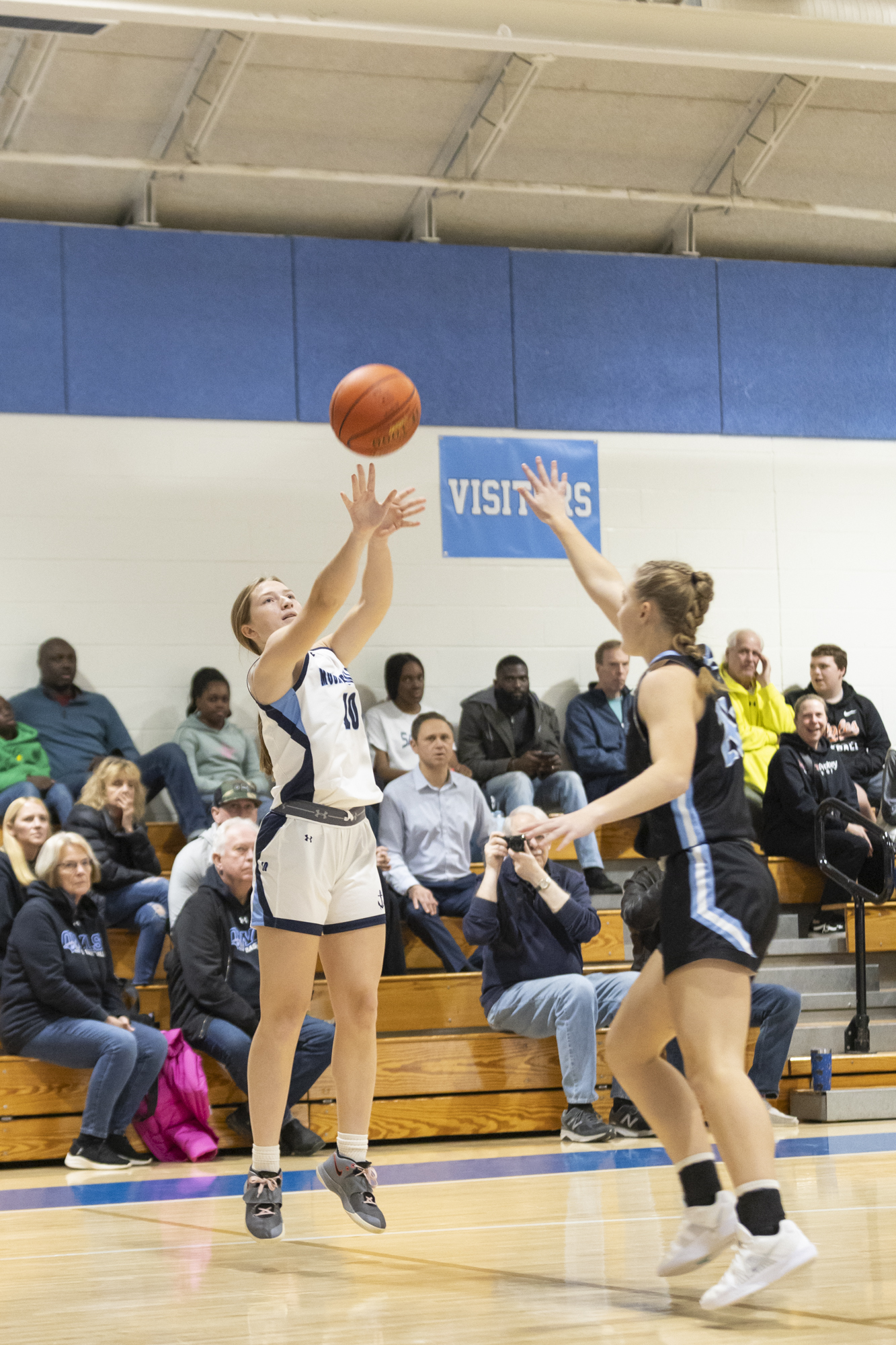 Cecilia Hannibal shoots the ball over the defense of Maddy...