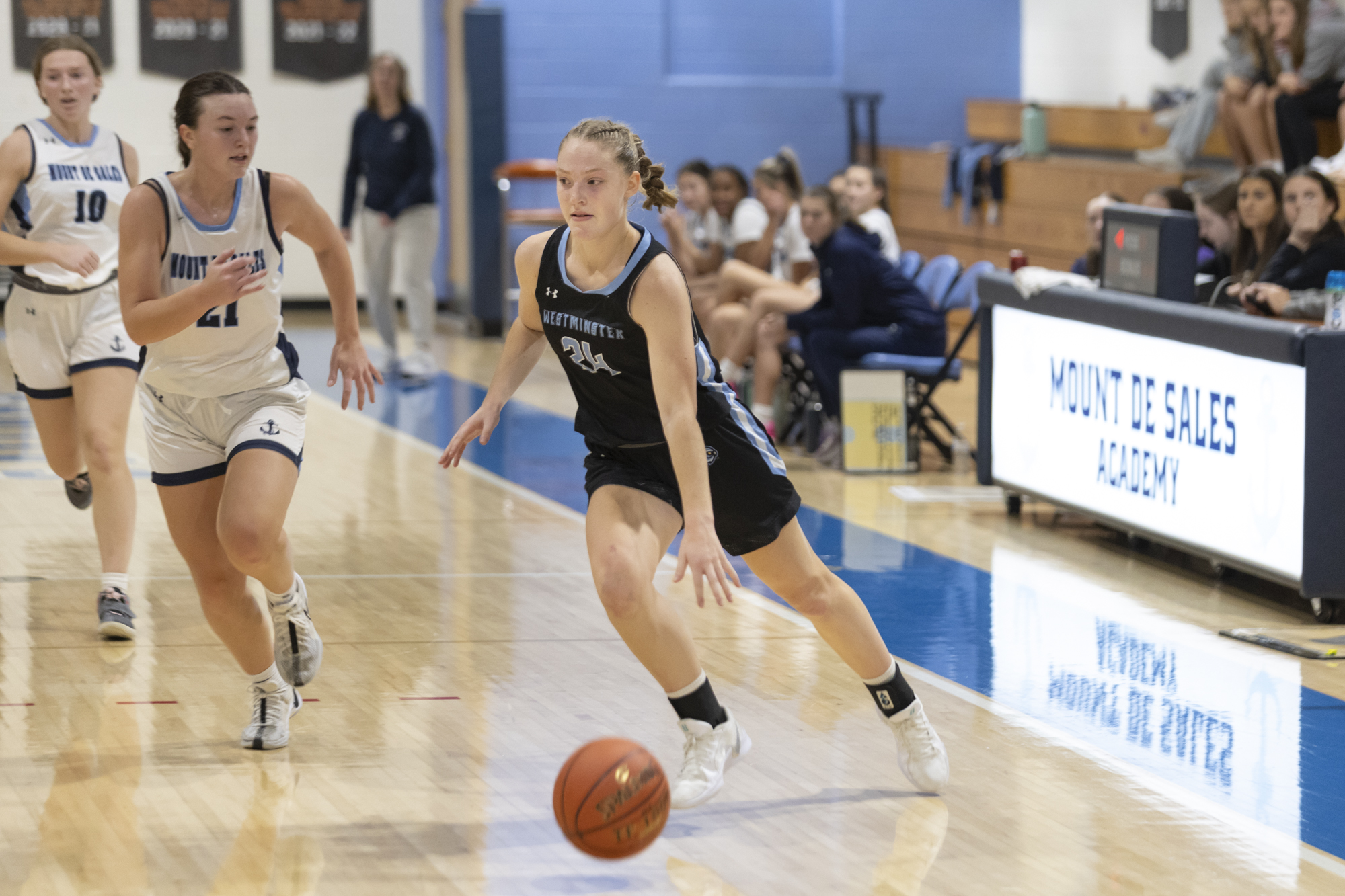 Westminster's Maddy Gassman drives into the offensive zone during the...