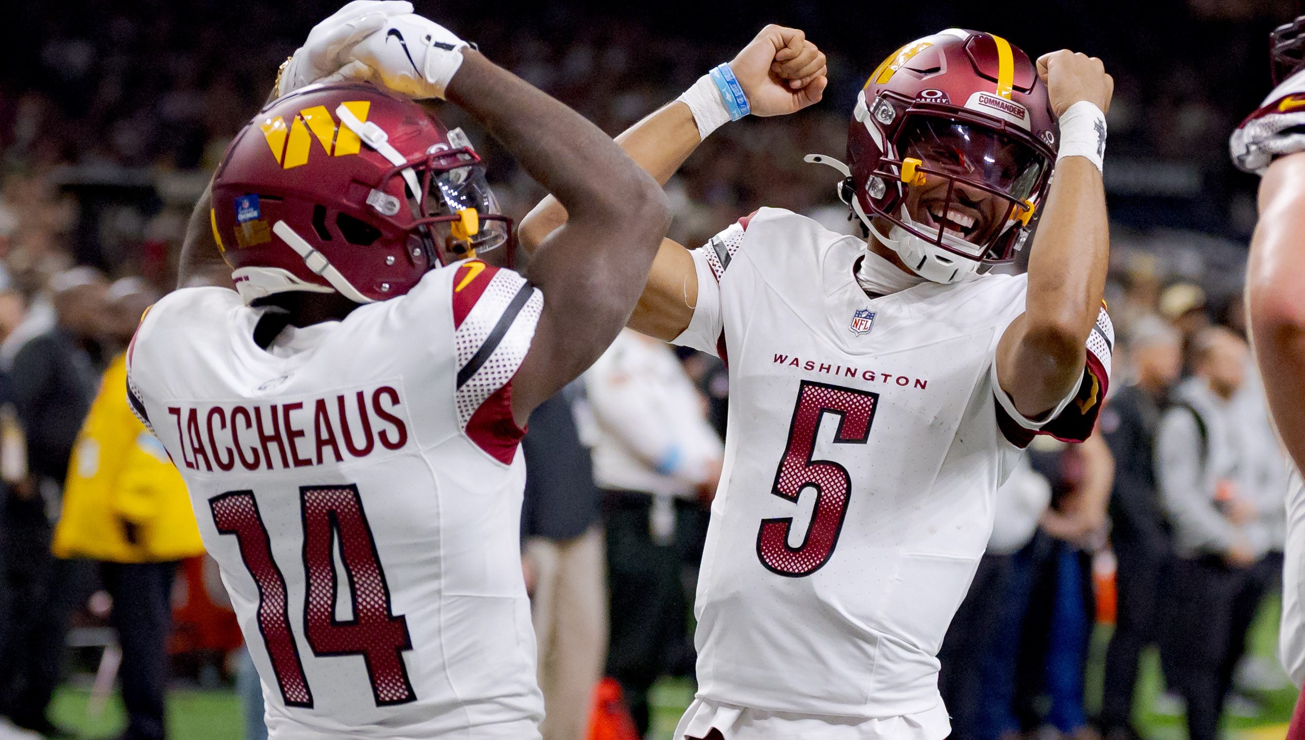 Washington Commanders quarterback Jayden Daniels (5) and Washington Commanders wide receiver Olamide Zaccheaus (14) celebrate a touchdown against the New Orleans Saints that was later called off due to a penalty against Washington during an NFL game at Caesars Superdome in New Orleans, Louisiana.