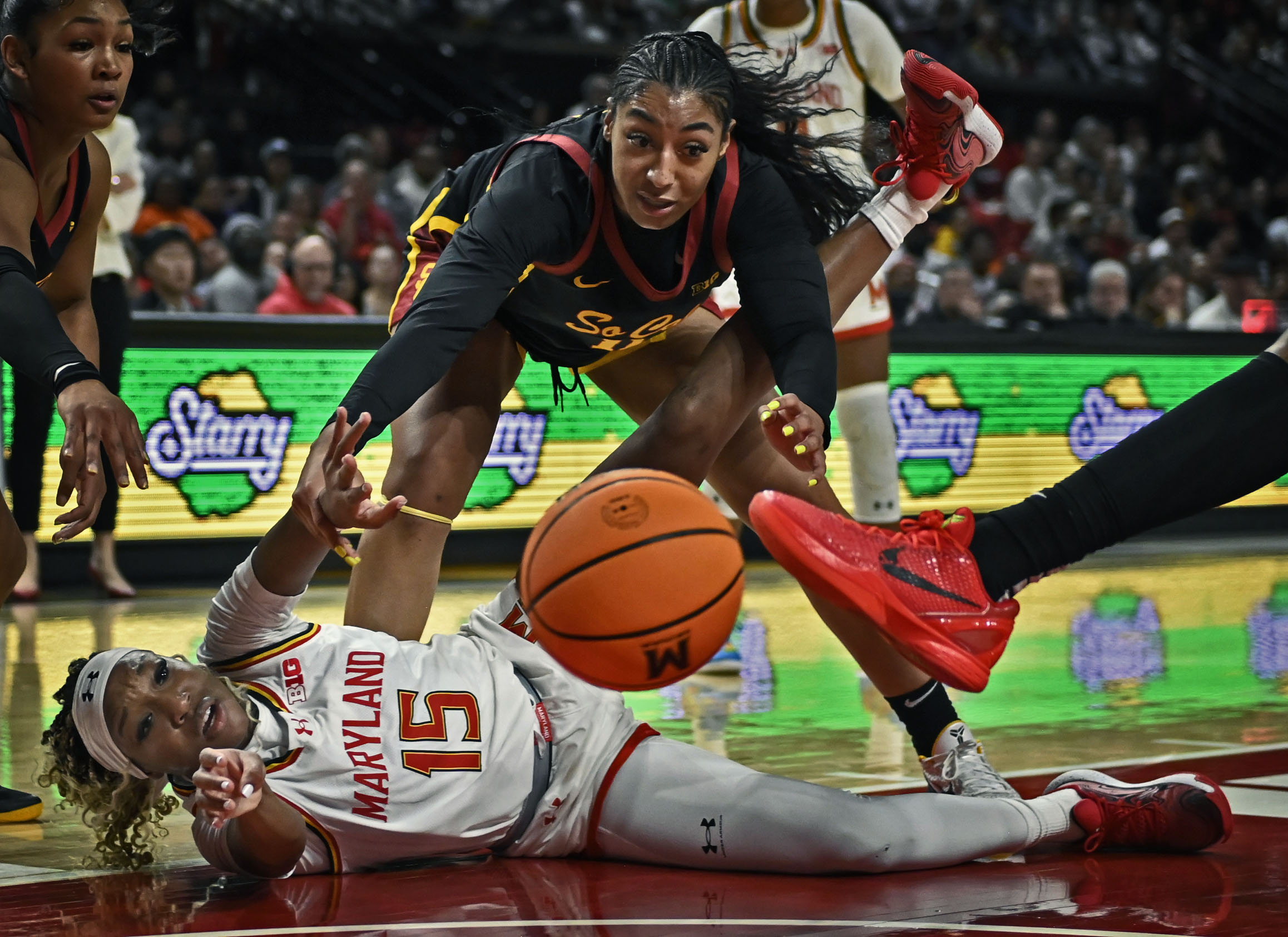 Maryland’s Christina Dalce, left, passes the ball to a teammate...