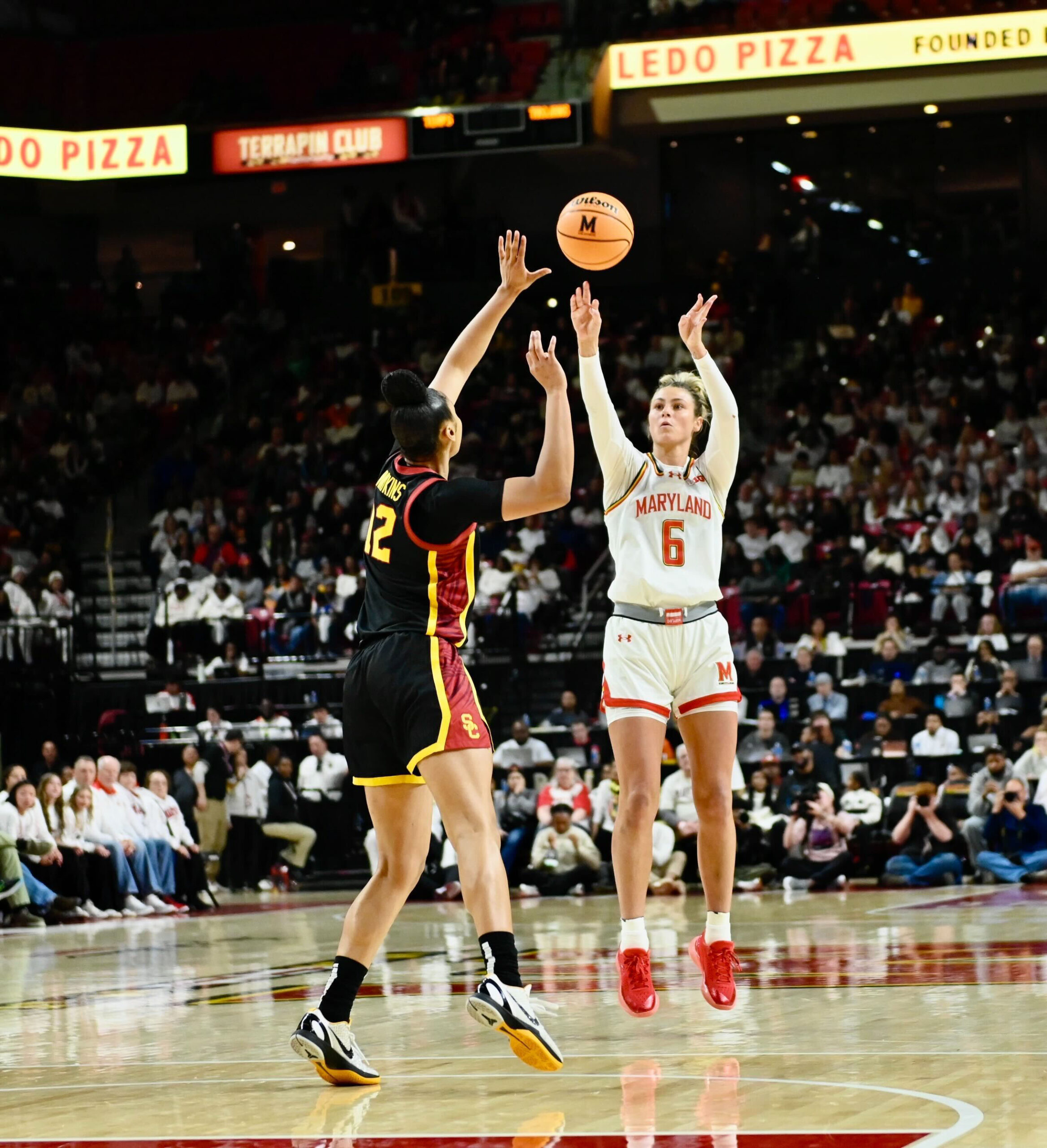 Maryland’s Saylor Poffenbarger scores a three pointer over USC’s JuJu...